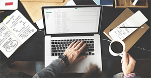 man checking emails on laptop