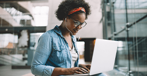 female student working on secure laptop 