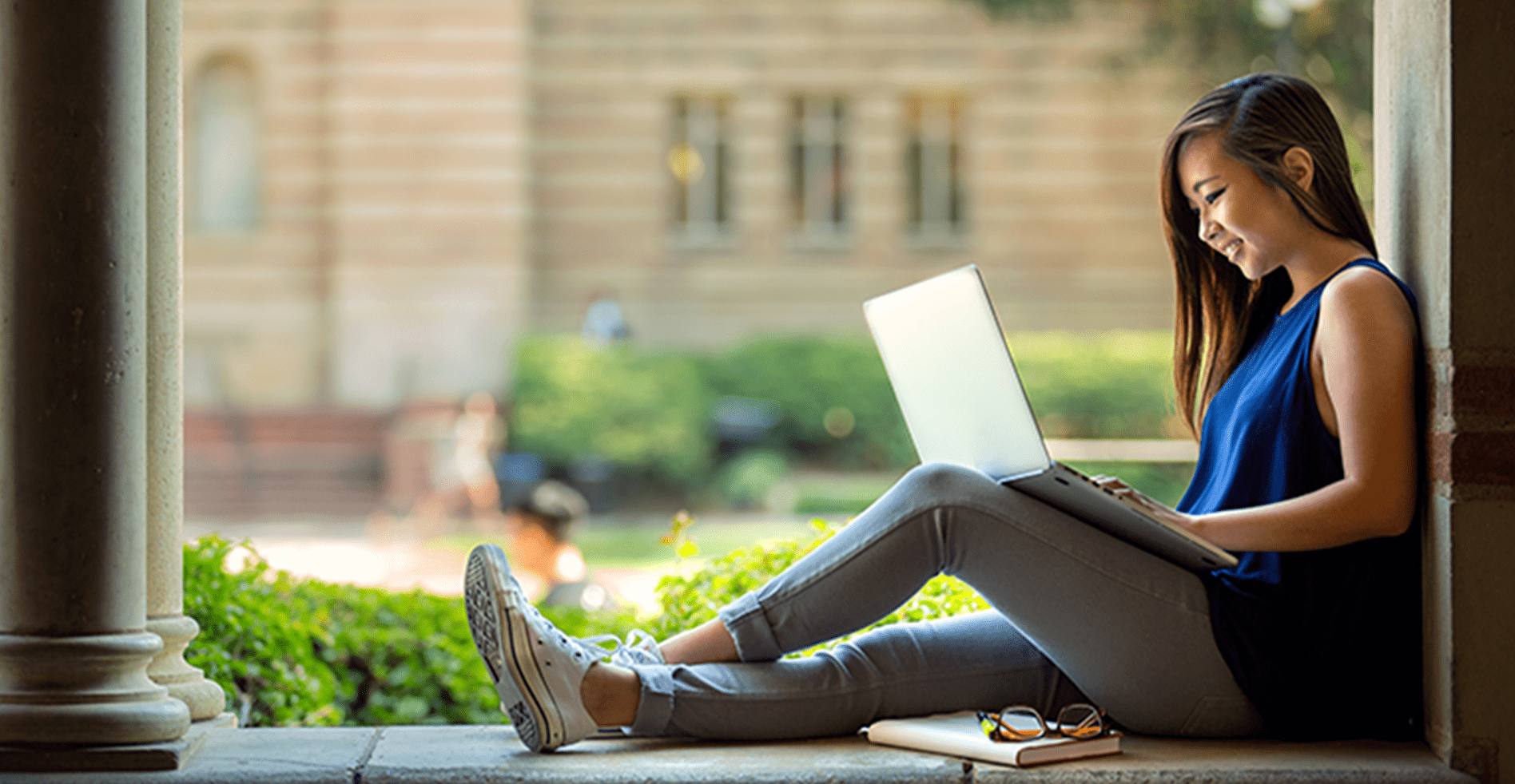 girl using laptop at college