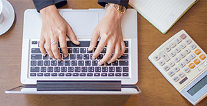 woman typing on laptop