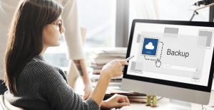 woman backing up her data on computer