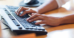 person typing with keyboard