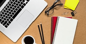 laptop and stationary supplies on desk